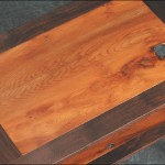 Detail showing the knot holes in the bookmatched yew panels of the walnut end tables 